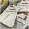 Marble contact paper featuring white and gold veining used for DIY decor projects.
