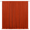 A floor-to-ceiling orange pleated fabric backdrop for events