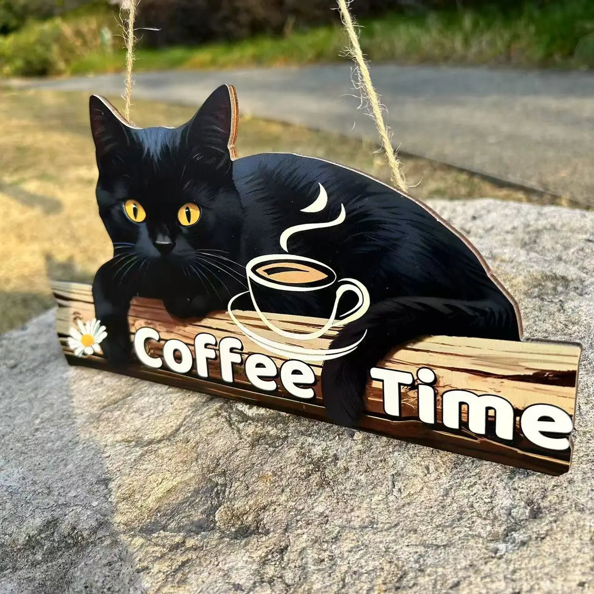 A black cat illustration with a steaming coffee cup design on a rustic wooden hanging sign.