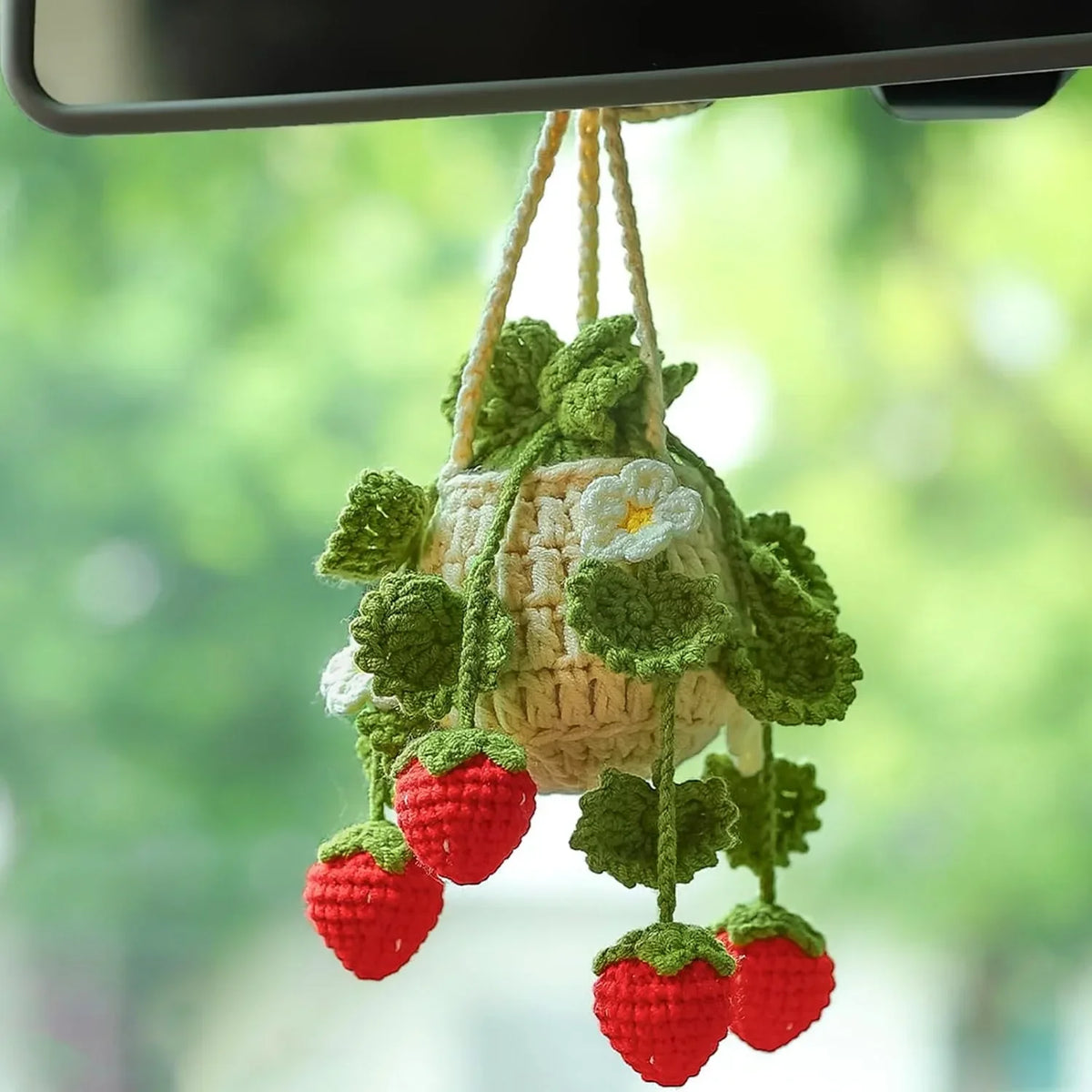 Hand-knitted hanging plant basket with green leaves and red strawberries for car mirror décor
