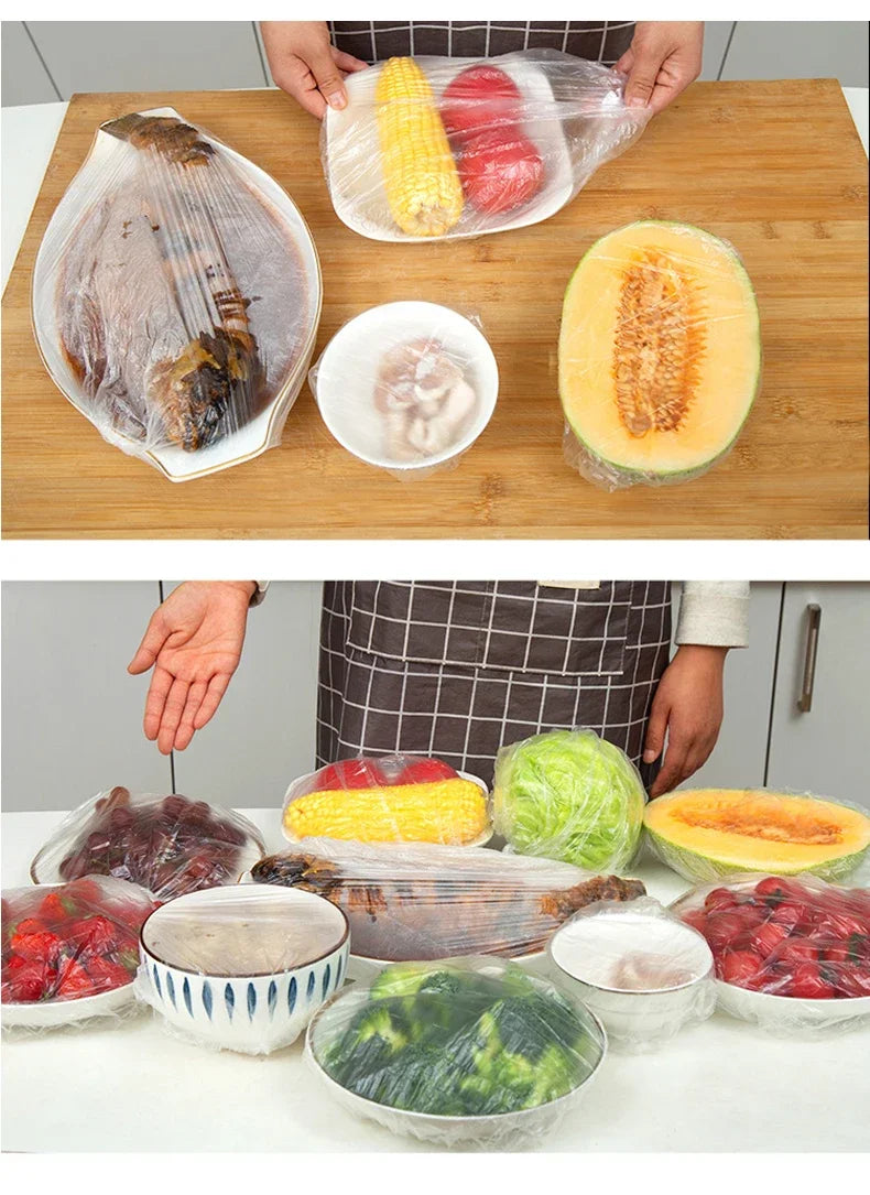 Various fresh vegetables and meats are displayed in reusable plastic food wrap covers on a wooden table.