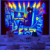 A person is playing a glowing UV reactive game controller on a desk in a dark room, surrounded by colorful light displays.