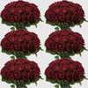 A collection of deep red velvet artificial roses in bouquets for weddings and home décor.