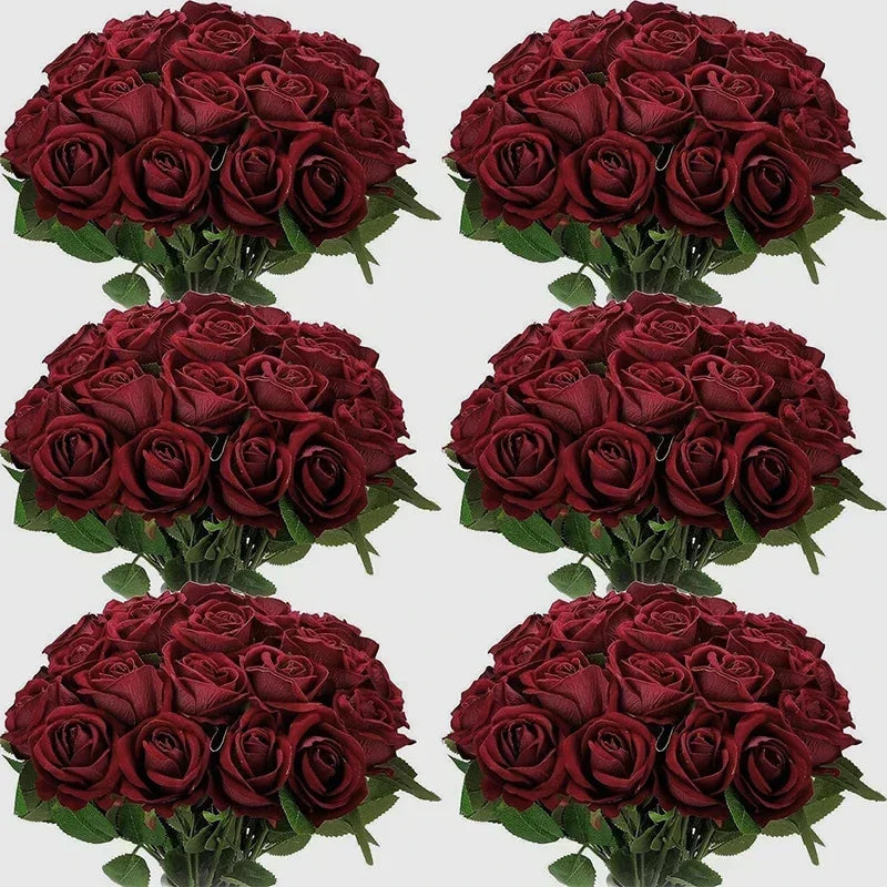 A collection of deep red velvet artificial roses in bouquets for weddings and home décor.