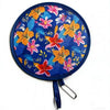 A round fabric fan featuring a vibrant floral pattern of orange, pink, and yellow flowers on a blue background.