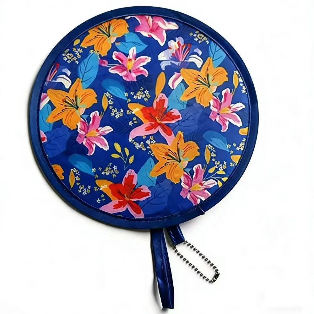 A round fabric fan featuring a vibrant floral pattern of orange, pink, and yellow flowers on a blue background.