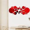 Abstract red circular mirror decals arranged in a scattered pattern on a white wall.