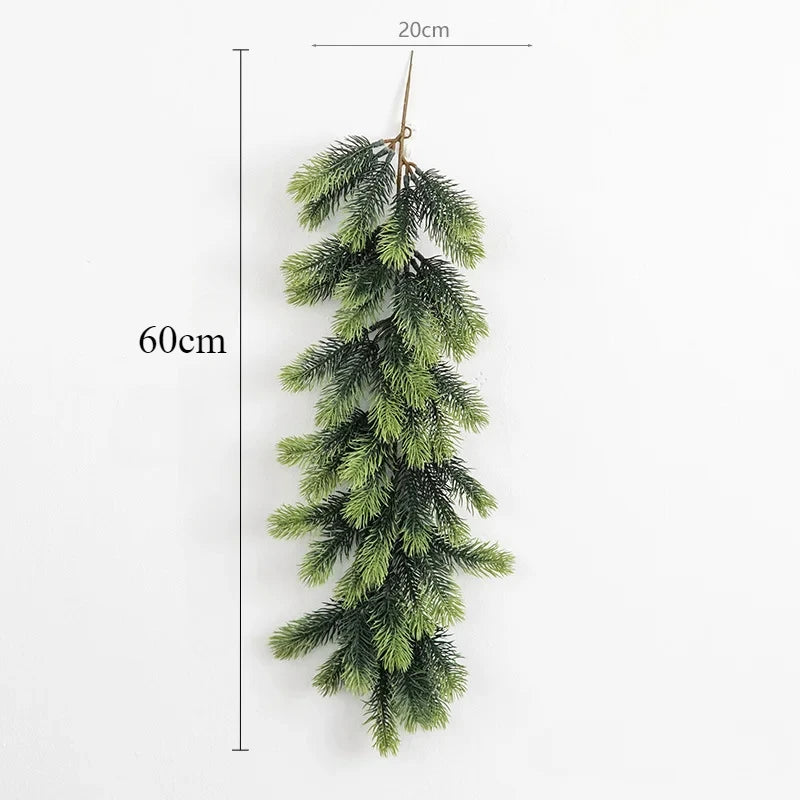 A long, artificial green pine garland hanging vertically against a white background.