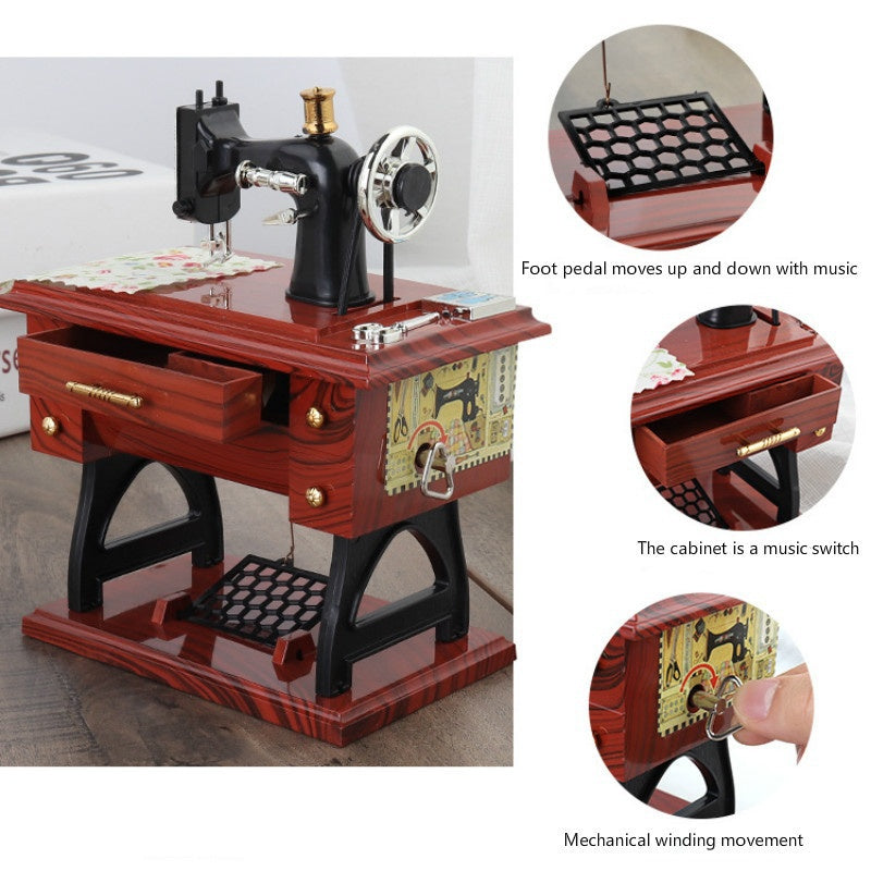 A wooden vintage sewing machine music box featuring a foot pedal and mechanical winding movement.