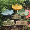 A set of decorative plant pots shaped like flowers, labeled Gups for bee and butterfly watering station.