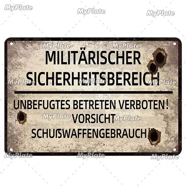 A weathered metal tin sign with German text warning about a military security area and prohibiting entry.