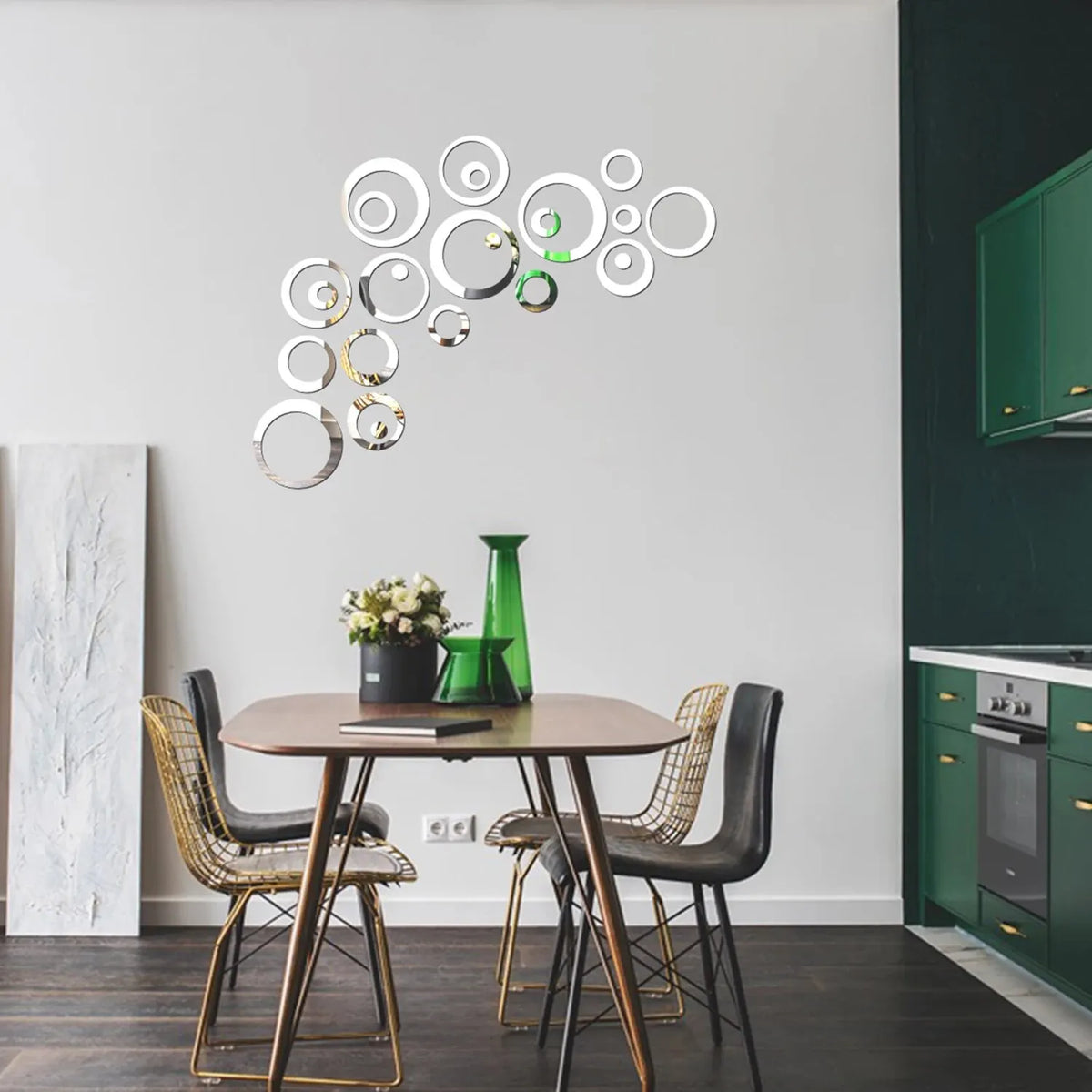 A wall display featuring a collection of geometric hollow circle mirror stickers on a white wall above a wooden table.