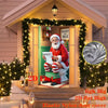 A festive Christmas decor featuring a Santa figure and greenery on a door cover.
