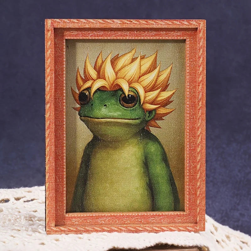 A cute green frog illustration framed in a wooden photo frame.