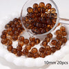 A clear glass bowl filled with round amber spacer beads for jewelry making