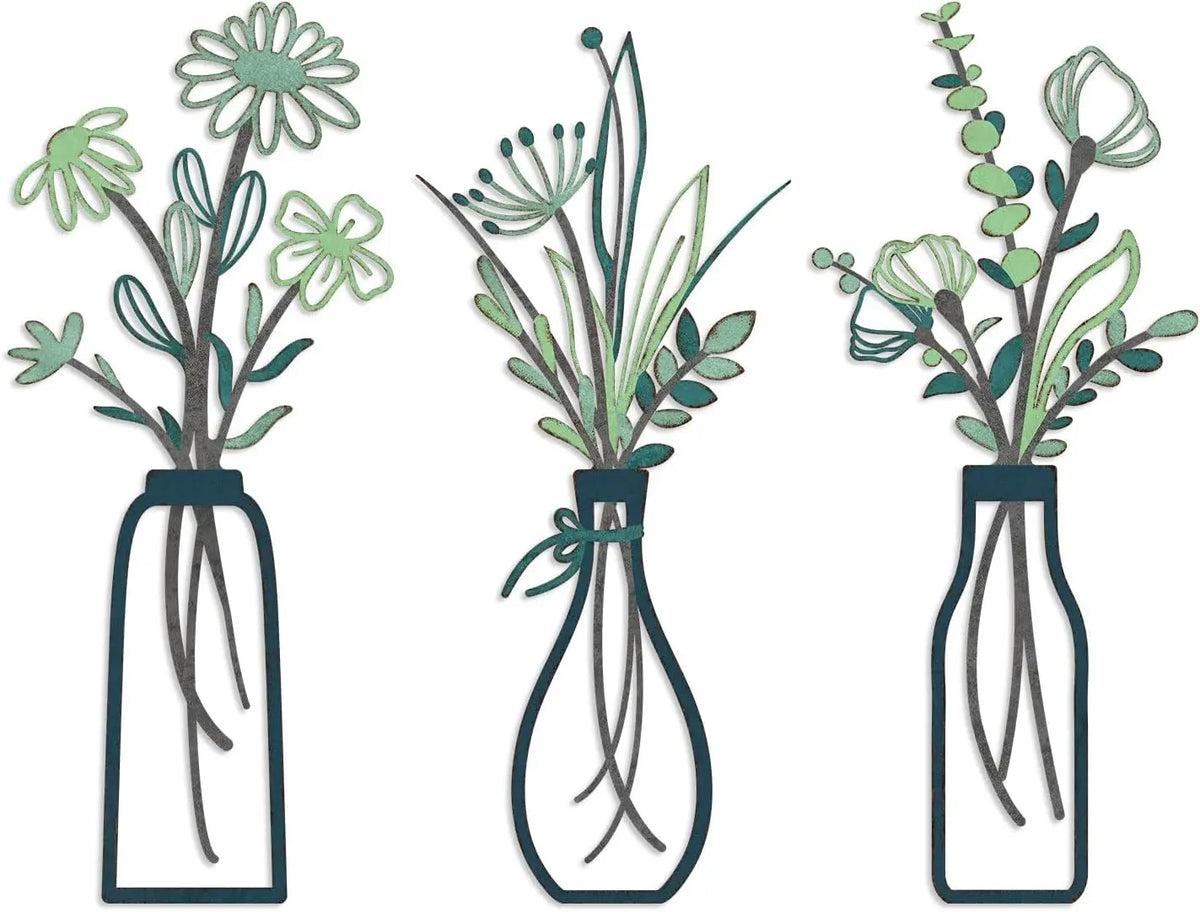 Set of three rustic metal flower arrangements in glass vases with green foliage.