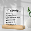 A clear acrylic desk plaque with black text listing positive affirmations like You are enough and Be kinder to yourself.