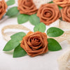 A cluster of artificial real touch foam roses in various shades of brown and green leaves on a white background.