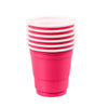 A stack of five bright pink disposable shot glasses with white rims.