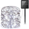 A bundle of clear fairy string lights with individual LED bulbs and a black solar panel connector.