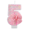 Glitter number cake candle with a pink bow shaped like the number 5 for birthday or anniversary