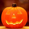 An orange glowing Halloween pumpkin lantern with a carved jack-o'-lantern face.