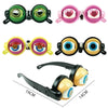 Pair of funny crazy eye costume glasses in green and pink colors