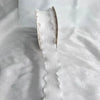 A close-up of a white decorative fishtail yarn ribbon, showing its texture and shape.