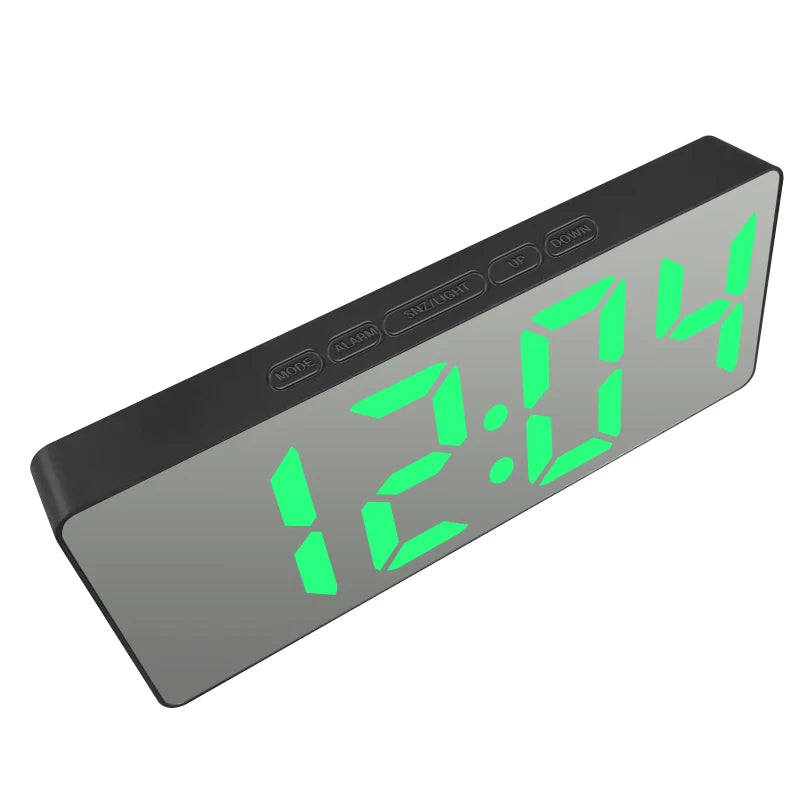 A digital LED alarm clock displaying 12:04 with mode and alarm settings visible on the front panel.