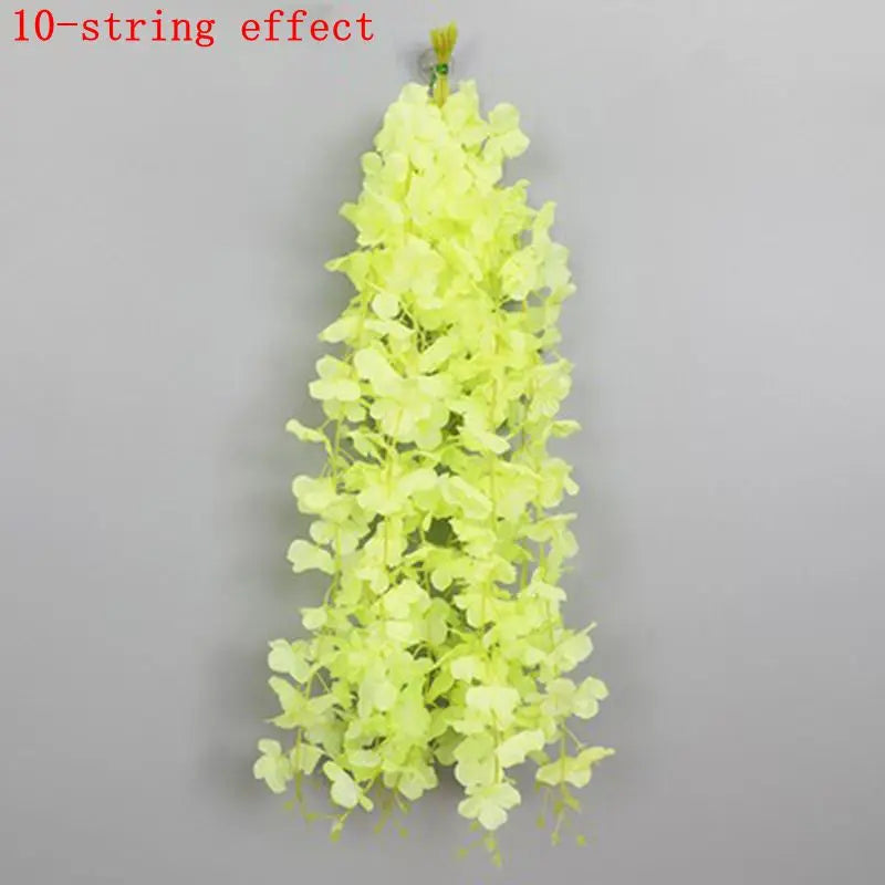 A vertical arrangement of light yellow artificial wisteria flowers forming a hanging garland.