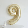 A large gold foil number balloon shaped like the number 9 is displayed against a white background.