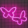 A pink neon sign shaped like a butterfly is mounted on a grid background.