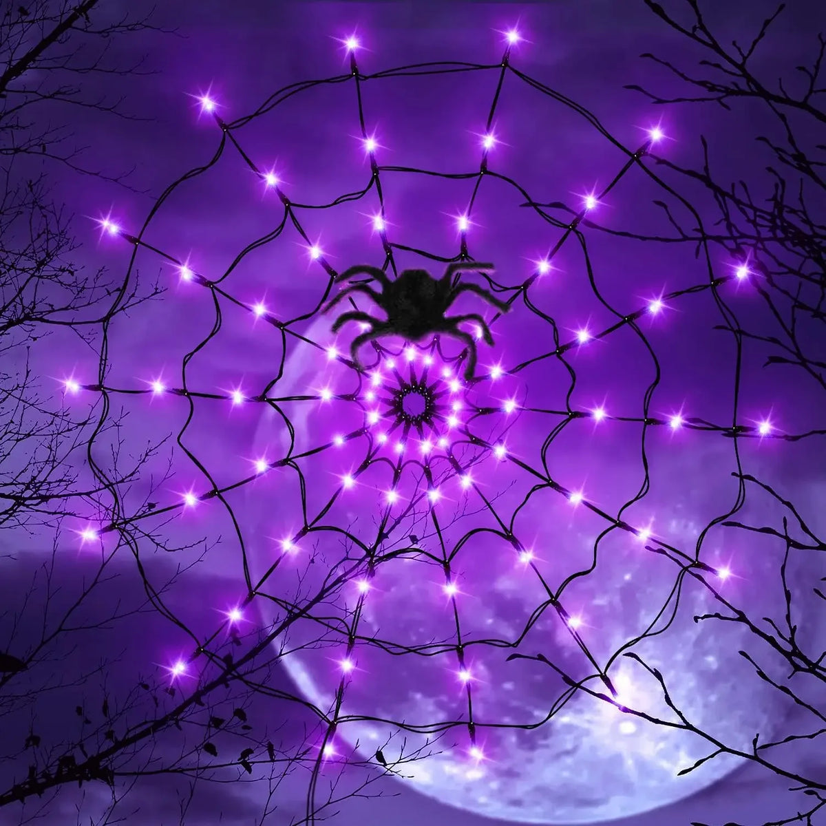 A purple spider web illuminated by bright LED string lights against a dark, moonlit background.