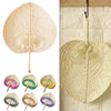 A collection of peach-shaped bamboo woven hand fans in various shades and patterns.