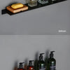 Modern matt black wall shelf displaying various glass and amber bottles for bathroom or kitchen