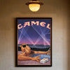 A vintage poster featuring a stylized camel silhouette against a purple and pink sunset background.