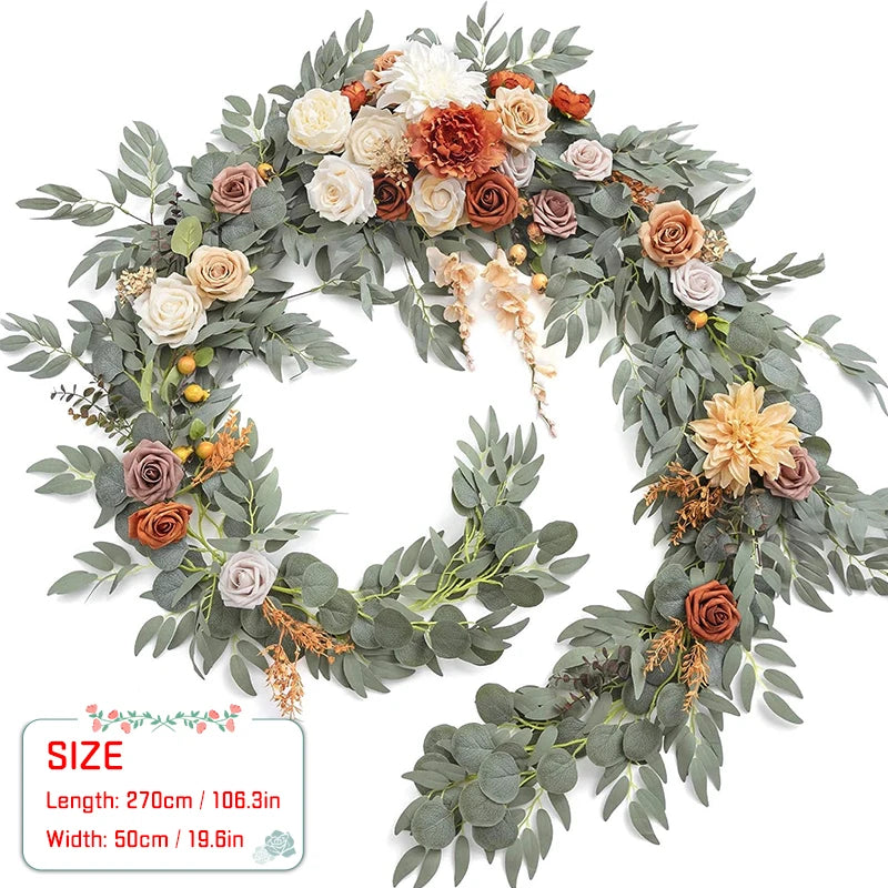 Artificial eucalyptus garland featuring roses in shades of dusty rose, cream, and orange for weddings and events