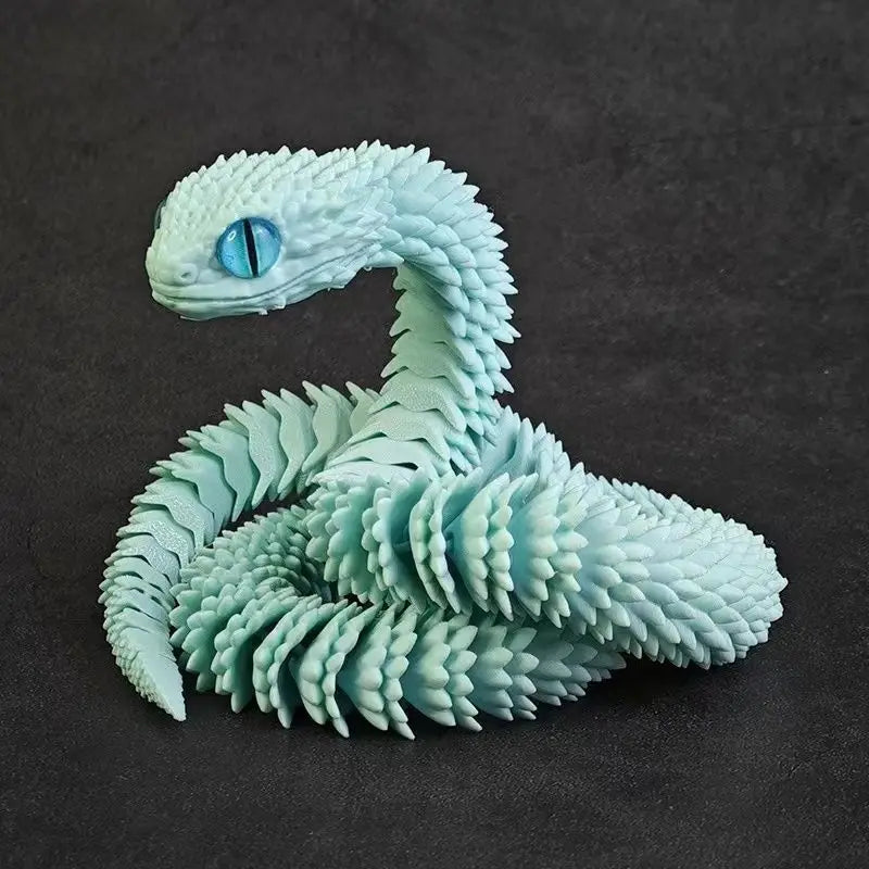 A light blue 3D printed model of a snake with textured scales and an eye, viewed from above.