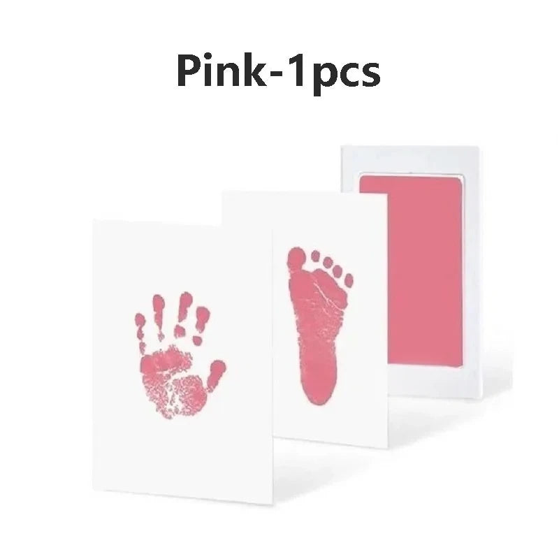 Pink handprint and footprint keepsake kit on white cardstock.