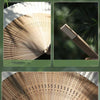 A close-up view of a bamboo folding fan with decorative perforations and a wooden handle.