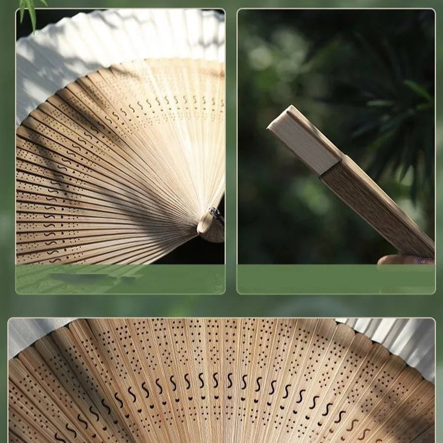 A close-up view of a bamboo folding fan with decorative perforations and a wooden handle.