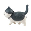 A cute gray and white cartoon cat figurine used as a refrigerator magnet.
