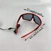 A pair of red and black wire-frame party glasses shown with measurements indicating size.