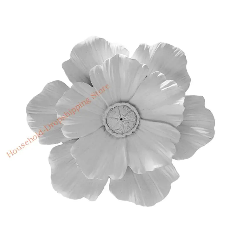 A close-up of a white layered resin floral wall decor flower.