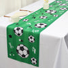 A green table runner decorated with soccer balls and the word fun for a party setting.