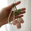 Handmade crocheted flower keyring charm featuring white pearls and pink fabric petals