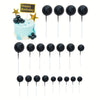 A set of twenty black mini foam ball cake toppers with gold star accents for birthday party decoration.