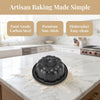 A set of four nonstick mini fluted cake pans is displayed on a white marble countertop.
