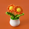 Hand woven crochet orange and yellow flowers in a white pot