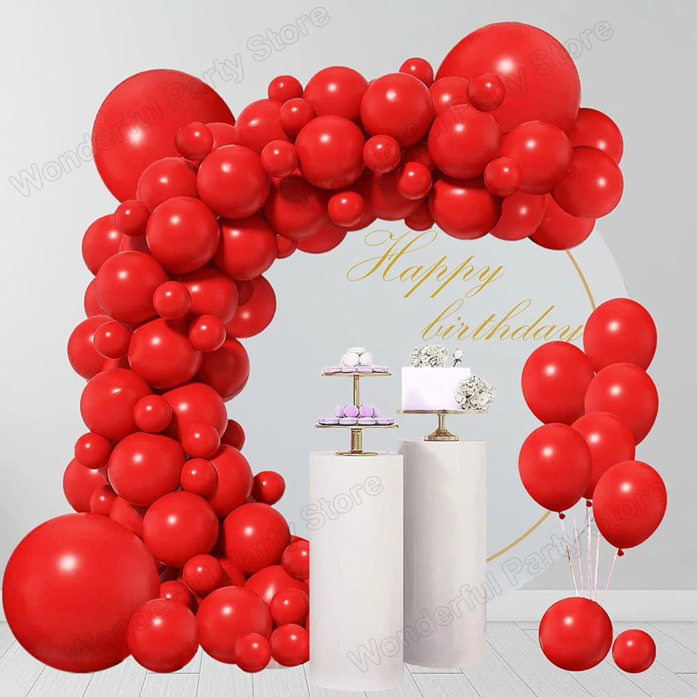 A vibrant red balloon garland arch display for parties and celebrations.